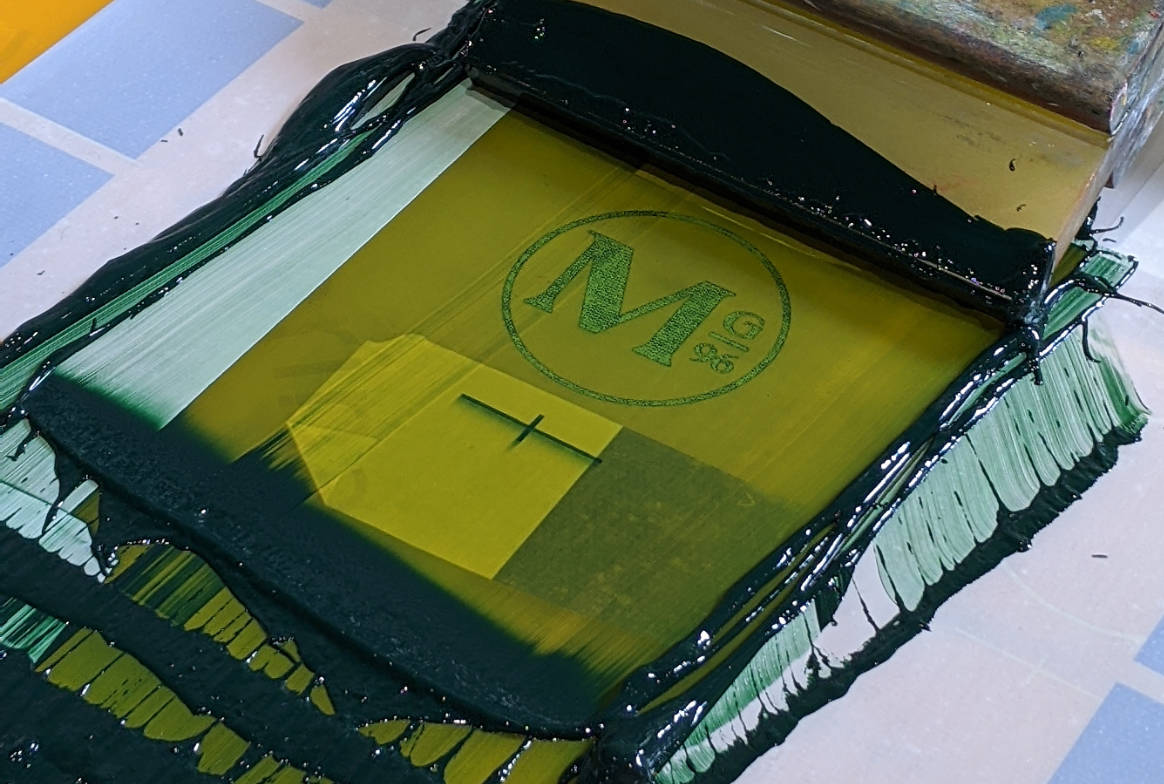 M logo on press